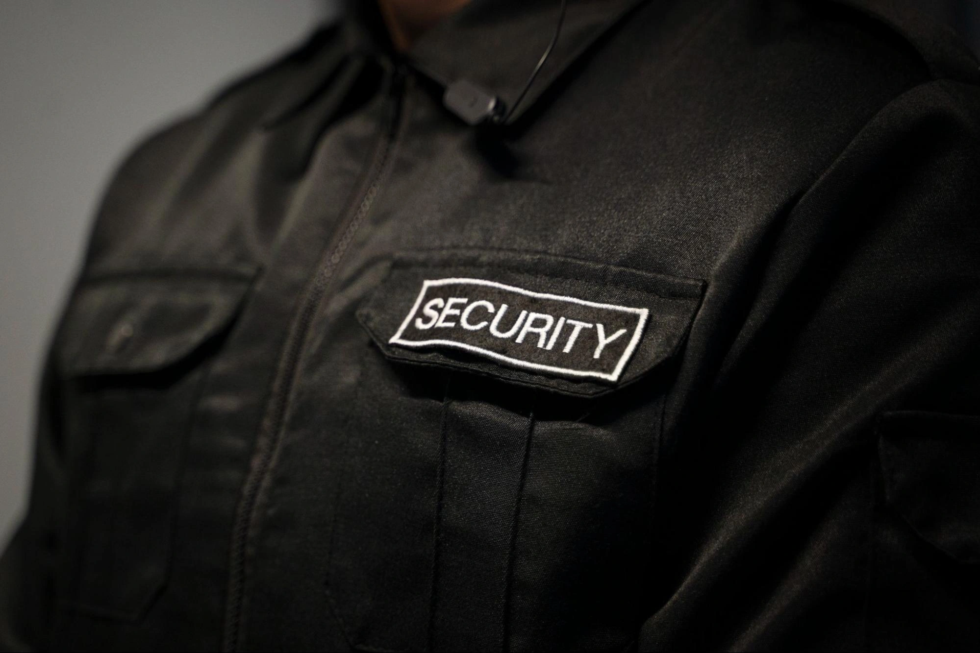 Close-up of a professional security guard uniform with a security patch.