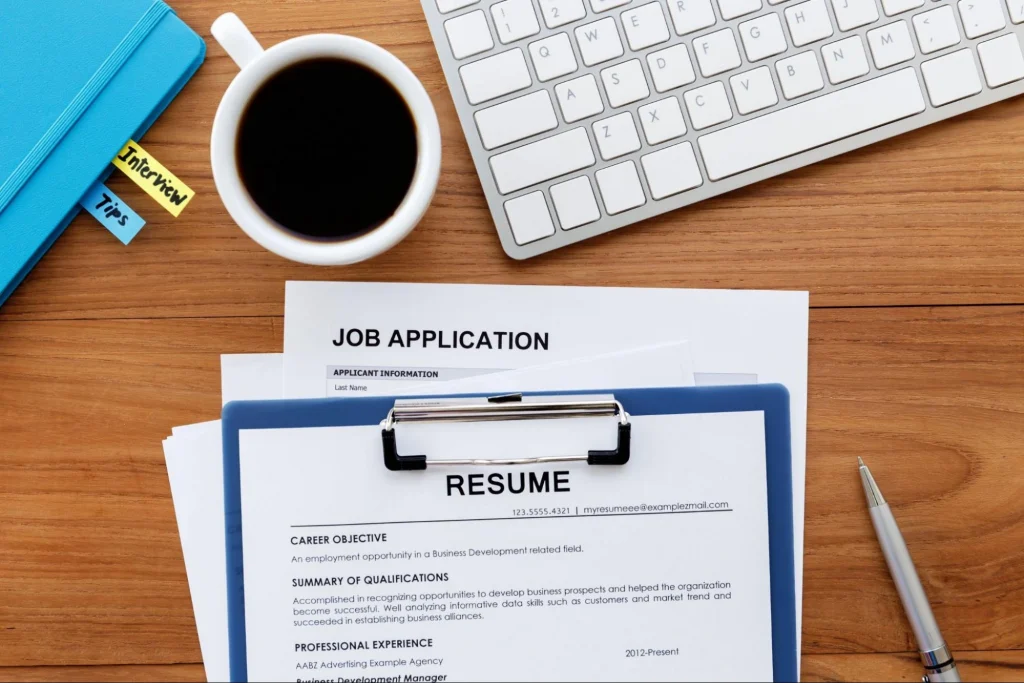 Job application and resume on a desk, prepared for a security guard position.