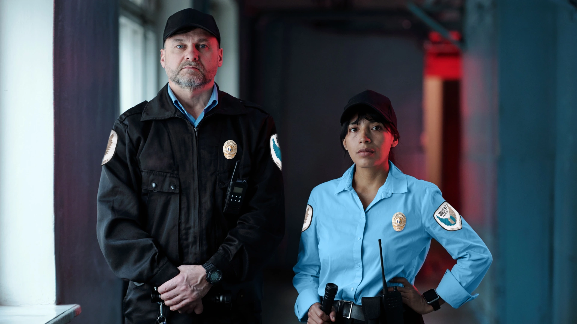 Two professional security guards standing in a training facility, representing current security guard training trends.