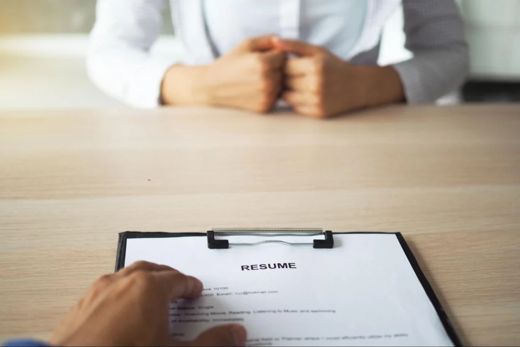 Close-up of resume during a job interview, illustrating the hiring process for trained security guards from Guard Training