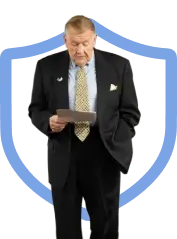 Security instructor reviewing training materials in front of a shield for Guard Training guard card classes online