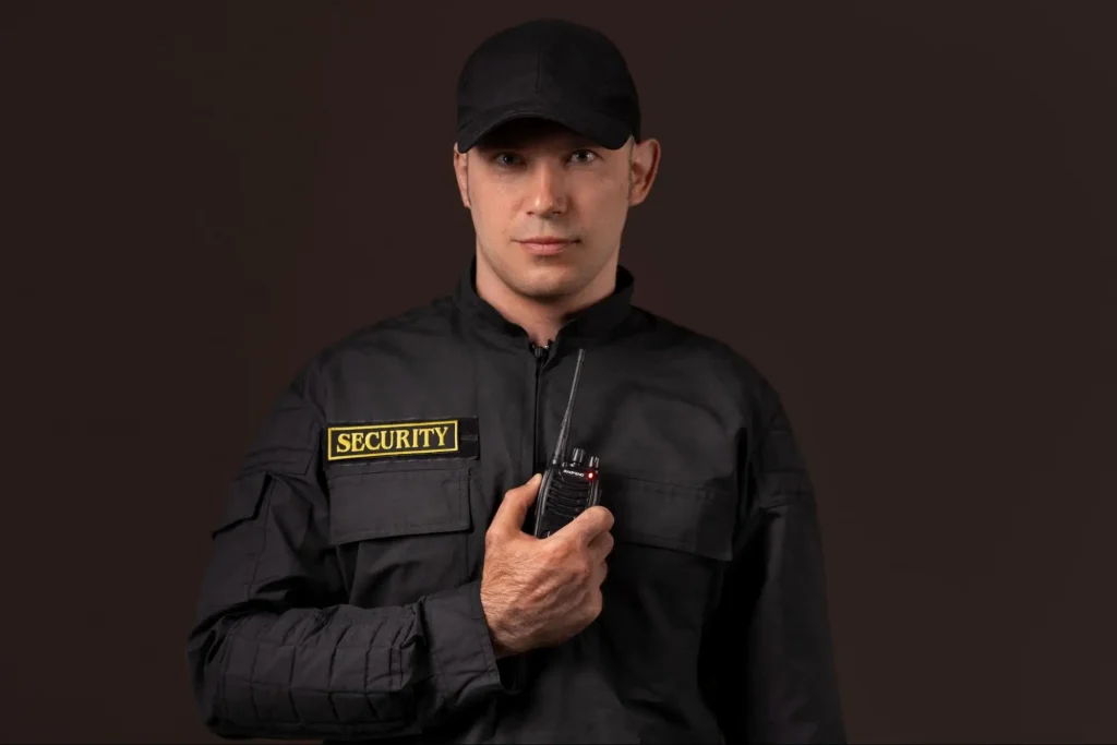 Security guard using a radio for communication during Guard Training coursework