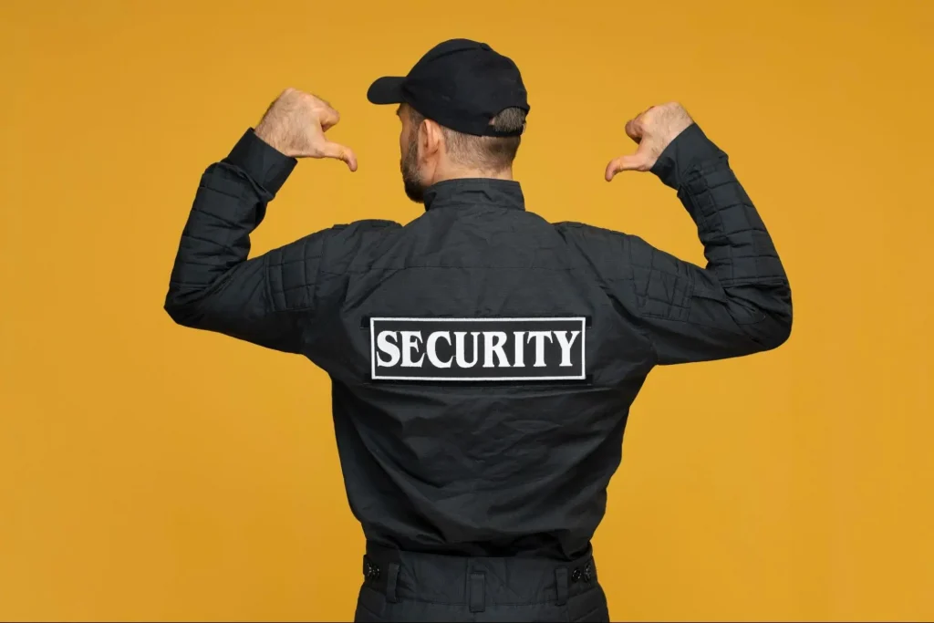 Security guard in uniform showing security badge for guard training