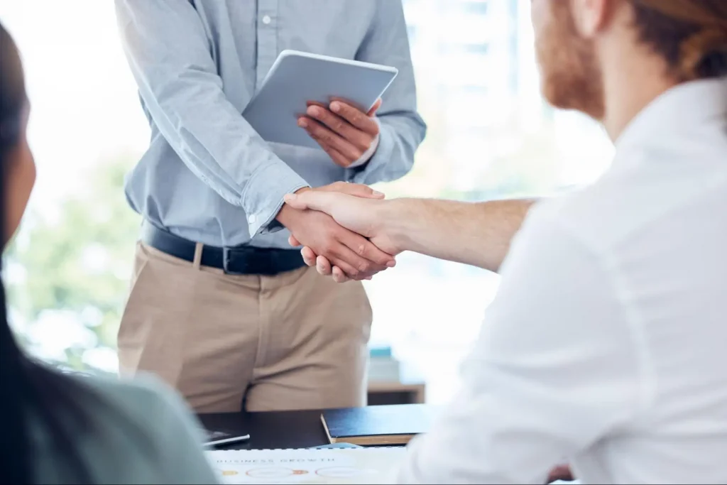 Job candidate shaking hands after completing online security training