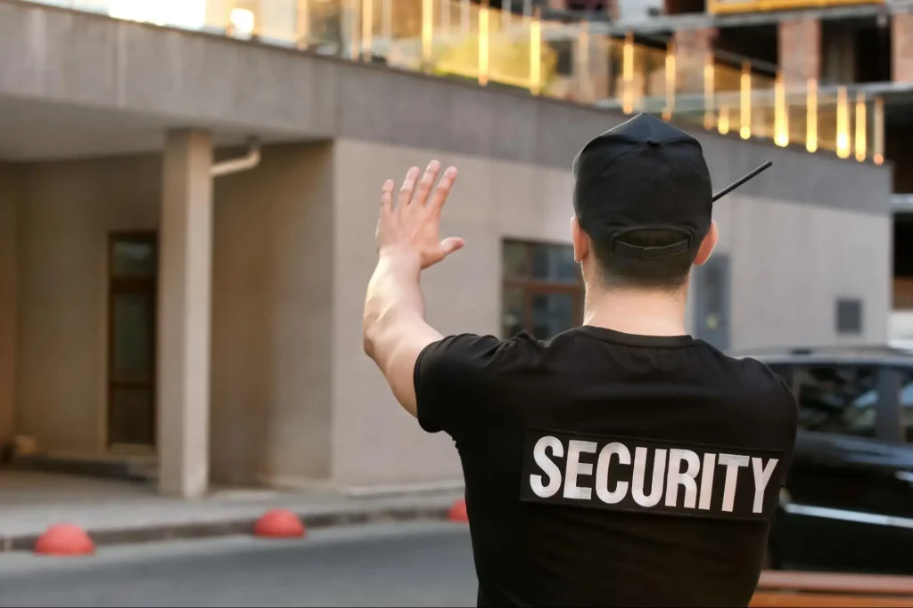 Security guard directing traffic and controlling access outside a building for Guard Training