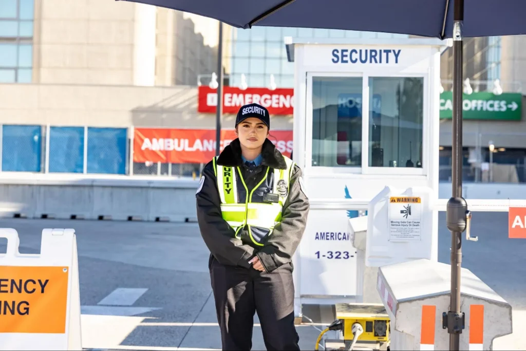Hospital security guard stationed near an emergency entrance after online security training with Guard Training